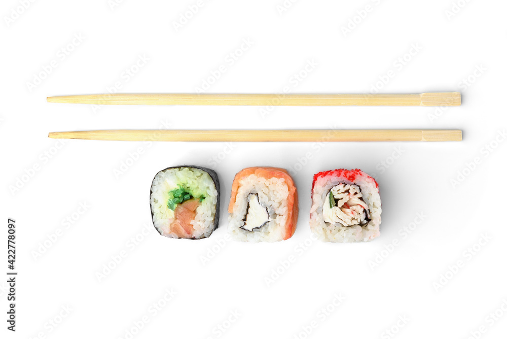 Three different sushi rolls and wooden chopsticks isolated on white background. Three different sushi rolls and wooden chopsticks isolated on white background.