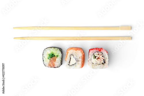 Three different sushi rolls and wooden chopsticks isolated on white background.