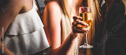 Photography glass of champagne in woman hand at a party
