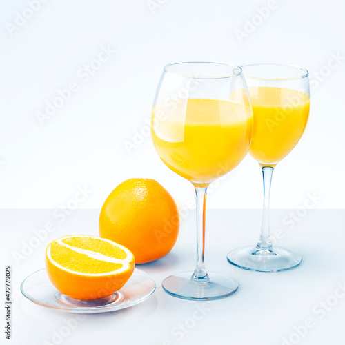  Two Glasses Of Orange Juice And Fruits.