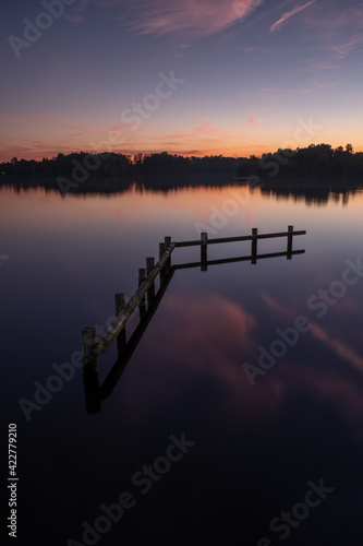 Sunset view of wooden boat dock in in lake in Groningen, the Netherlands photo