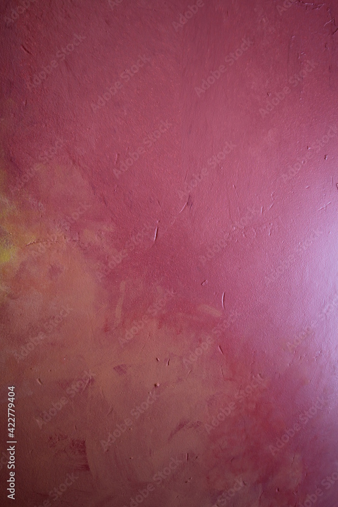 Fototapeta premium A painted plaster wall in varying shades of pink , an abstract background
