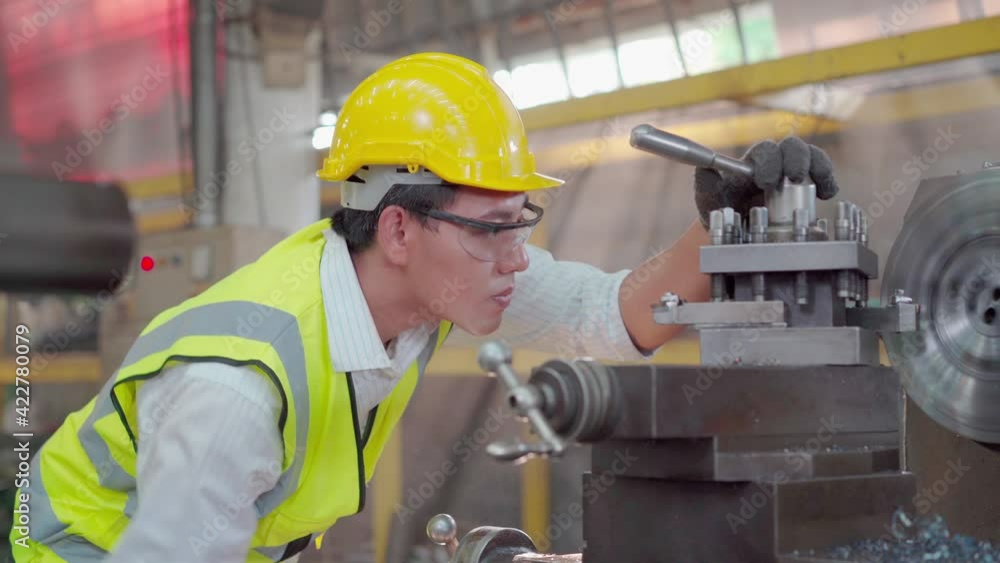 Manufacturing worker. Mechanical engineer who controls the lathe machine in the factory. Manufacturing worker. Mechanical engineer who controls the lathe machine in the factory.