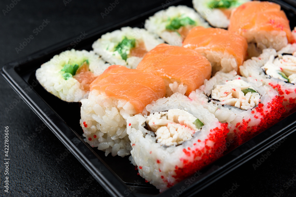 Sushi rolls on black background. Japanese food. Sushi rolls on black background. Japanese food.