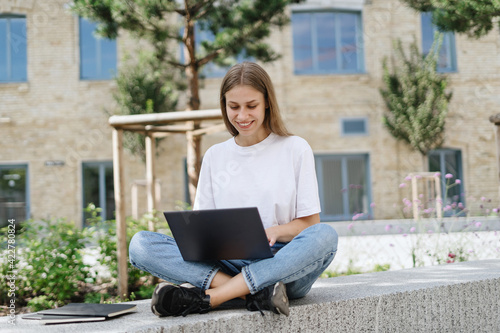 Adult student girl using modern laptop computer © brizmaker