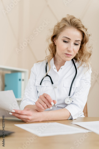 Woman doctor work with documents in clinic