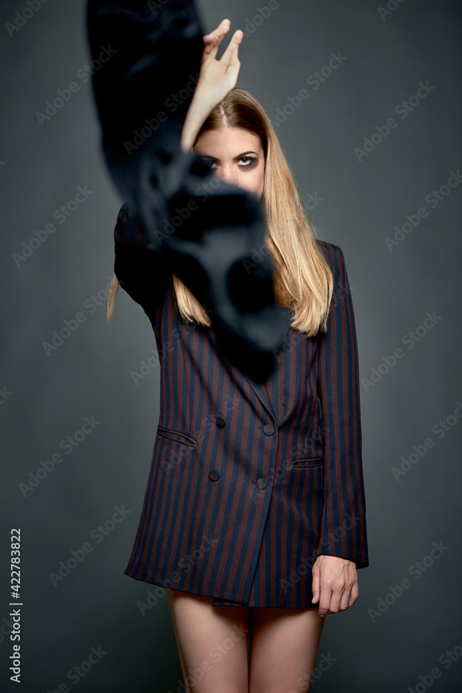 Studio photo of a blonde woman throwing a black foulard. Blonde woman throwing a black foulard Studio photo of a blonde woman throwing a black foulard. Blonde woman throwing a black foulard