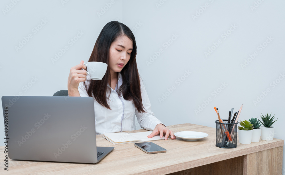 Asian women are working at home due to COVID-19 situation. concept work from home. Asian women are working at home due to COVID-19 situation. concept work from home.