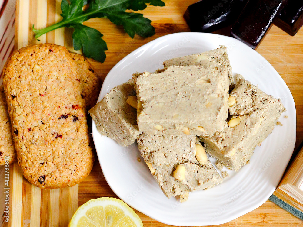 Flat lay a eastern sweets, halva on a white plate and a wooden background. Food. Delicious. Homemade sweets concept. Flat lay a eastern sweets, halva on a white plate and a wooden background. Food. Delicious. Homemade sweets concept.
