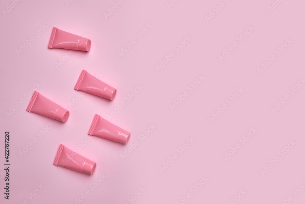 Blank pink cosmetic tubes on pink background. Blank pink cosmetic tubes on pink background.