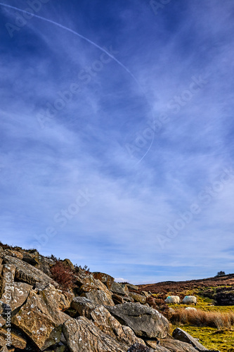 Curved vapour trail above moorland in Yorkshire.  photo