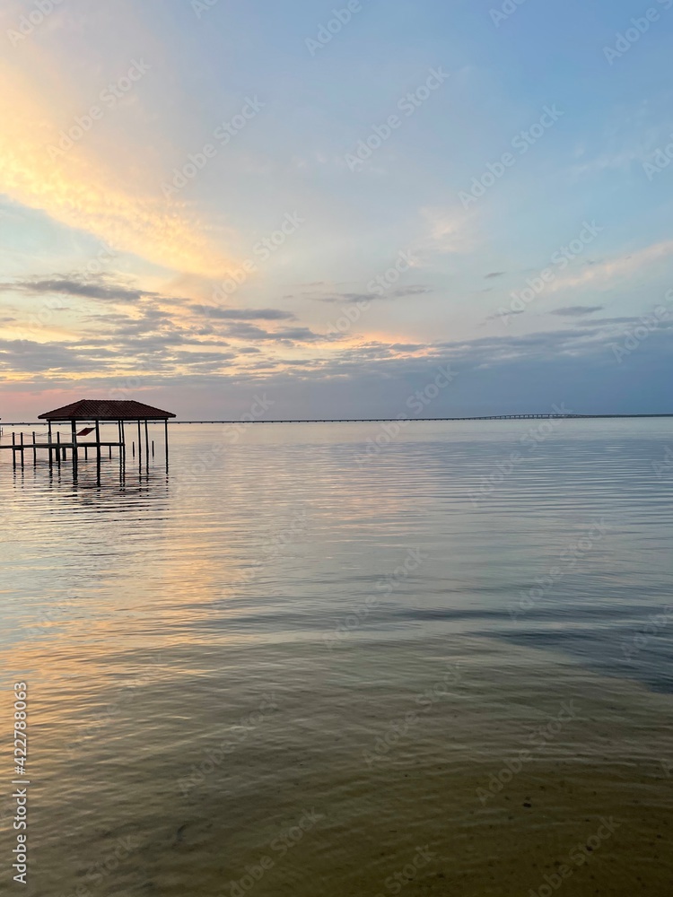 Fototapeta premium sunset with color reflections over bay water 