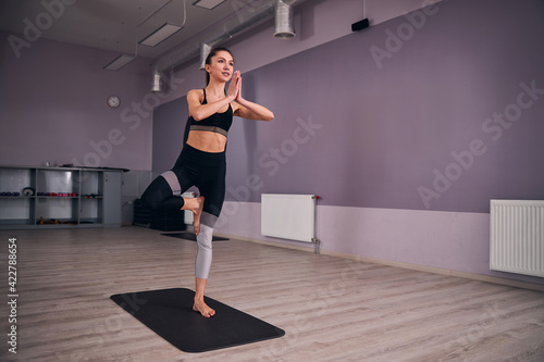 Young female person practicing yoga in the morning