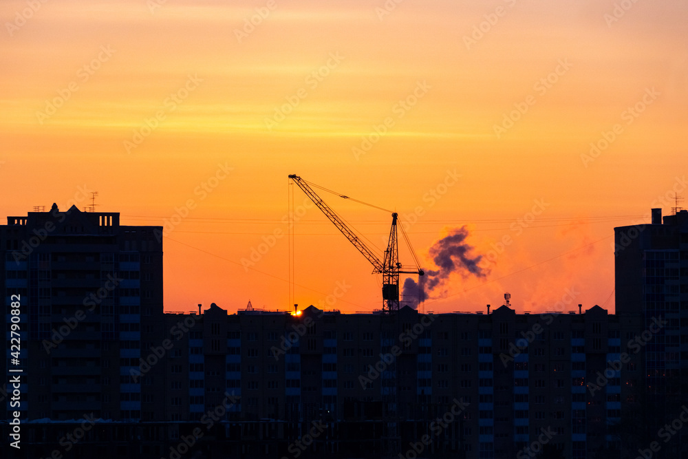sunset over the construction site and the city sunset over the construction site and the city