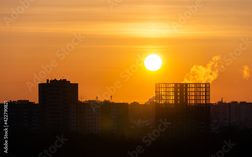 sunset over the construction site and the city