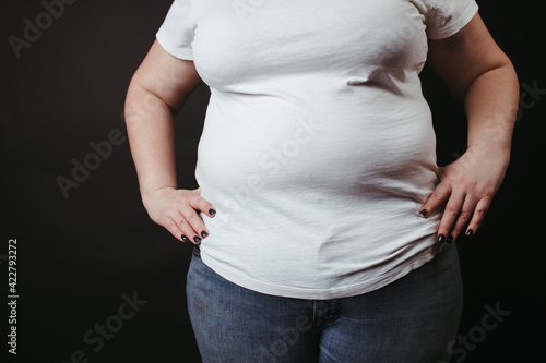 Fat people. Overweight woman at studio background