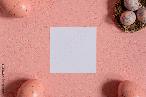 Easter pink background with eggs and card for text 