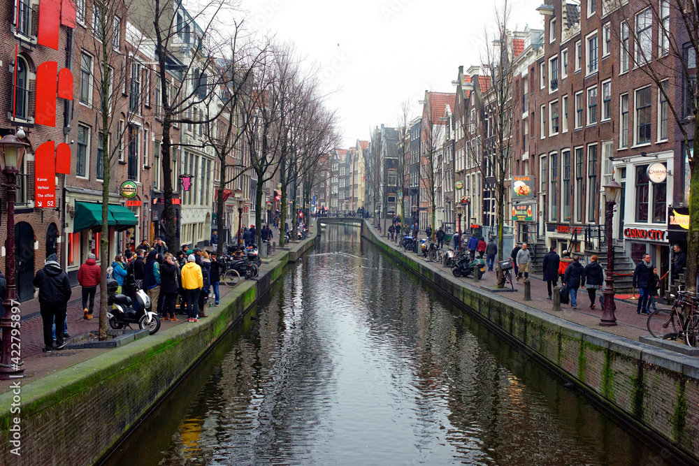   Along the canal walk citizens and moving vehicles