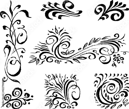Freehand drawings of various decorative floral vintage design elements