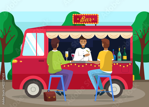Truck with bartender making alcohol drink for young people. Men buying cocktails from outdoor bar