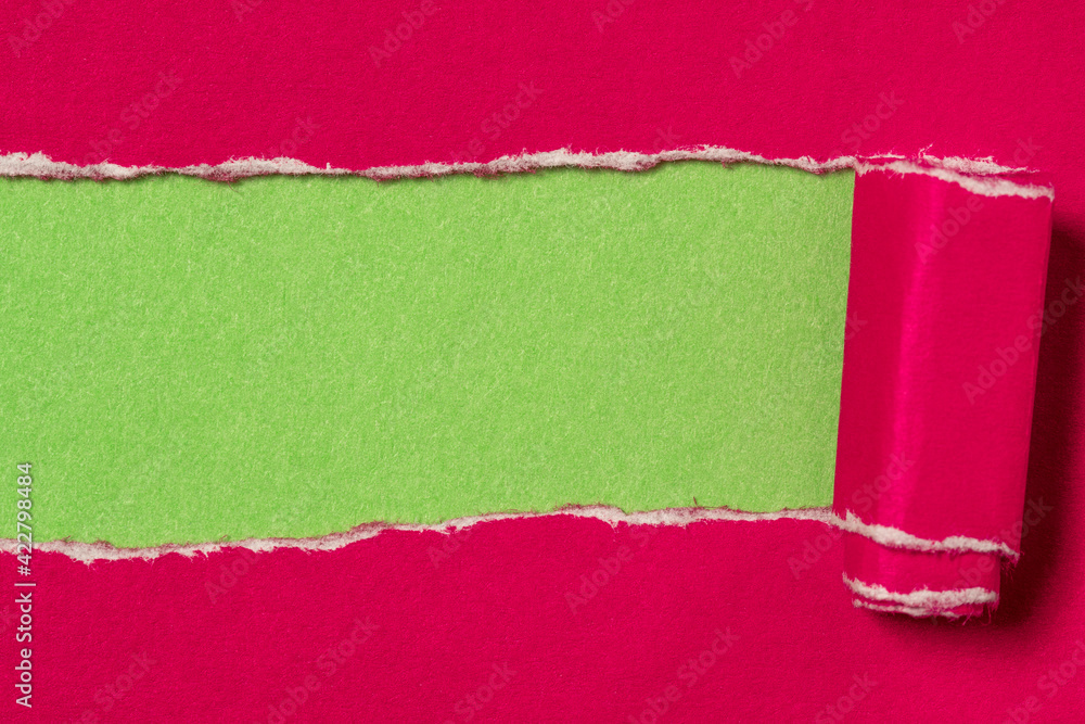 Pink torn paper to reveal green Pink torn paper to reveal green