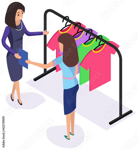 Woman communicating with consultant in shop while shopping. Clothes on hanger for sale in store