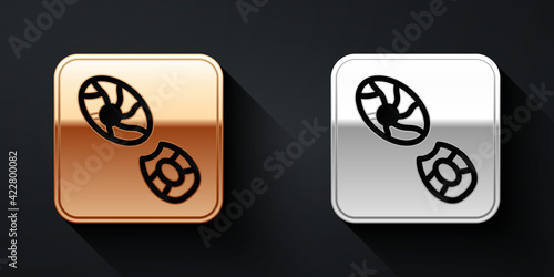 Gold and silver Human footprints shoes icon isolated on black background. Shoes sole. Long shadow style. Vector