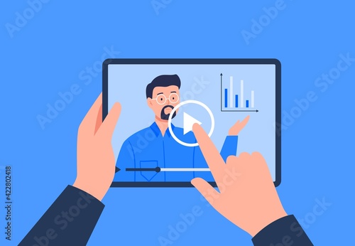 A hand is holding a tablet with a video player. Watching a video, course, webinar, tutorials online. Vector flat illustration.