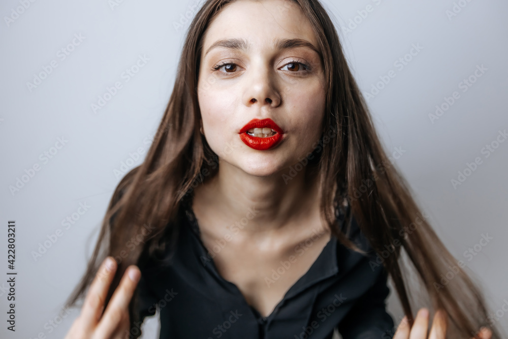 Beautiful woman straightens her long hair, close-up portrait Beautiful woman straightens her long hair, close-up portrait