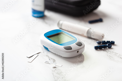 glucometer ketometer lancet and strips for self-monitoring of blood glucose or ketones level. diabetes or keto diet photo