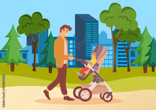 Young father walking with baby stroller in city park. Dad spend time with his son ourdoors