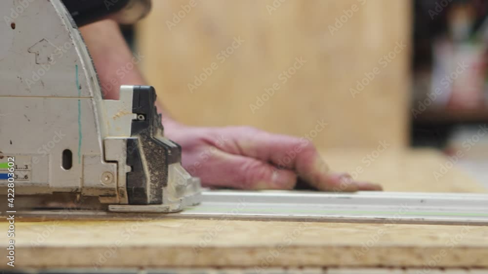 Closeup of circular saw cuting wood on a table for construction work Closeup of circular saw cuting wood on a table for construction work