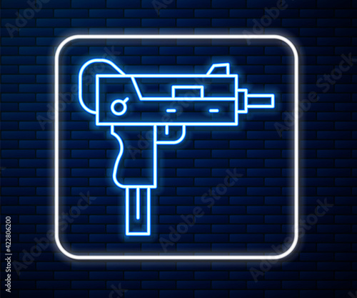 Glowing neon line UZI submachine gun icon isolated on brick wall background. Automatic weapon. Vector