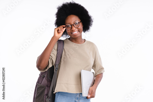 Fényképezés Smart african teen girl student with books in glasses isolated over white backgr