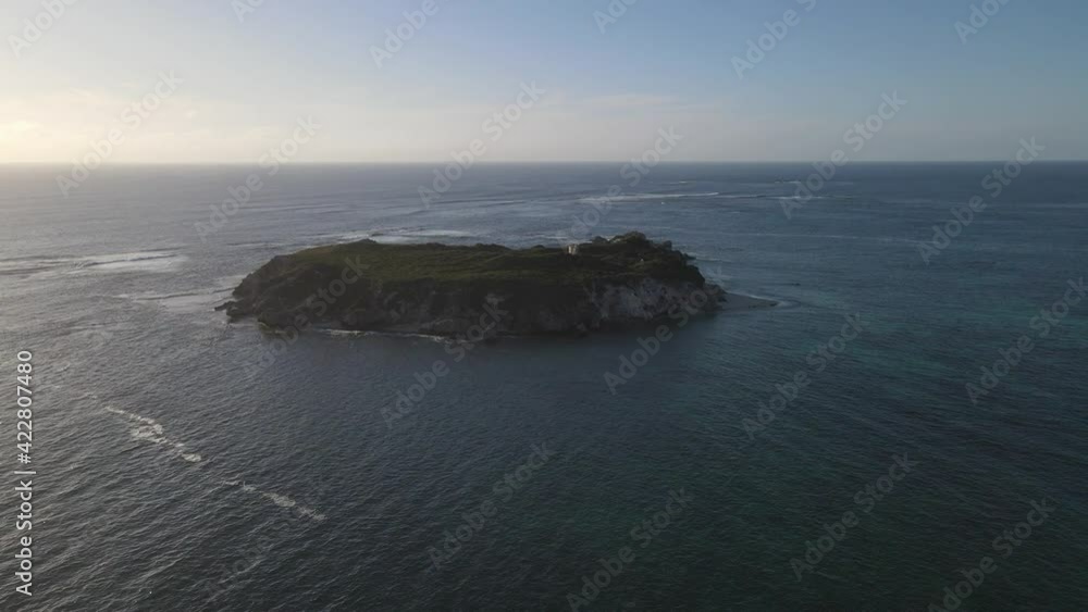 Aerial shot of Australian green lonely island with crashing waves during sunlight. Hamelin Bay,Australia. Aerial shot of Australian green lonely island with crashing waves during sunlight. Hamelin Bay,Australia.