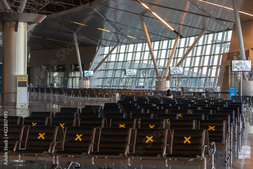 A lot of seats in the airport's international terminal are completely empty. There are no passengers at the airport. No people at the airport during the covid 19 coronavirus pandemic