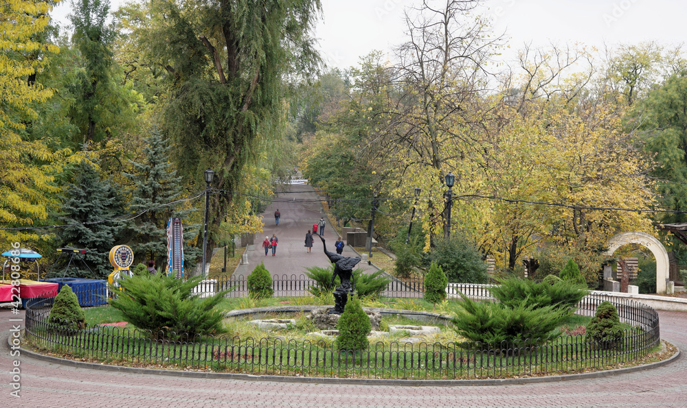 Pedestrians walk along Gorky Park in the autumn day