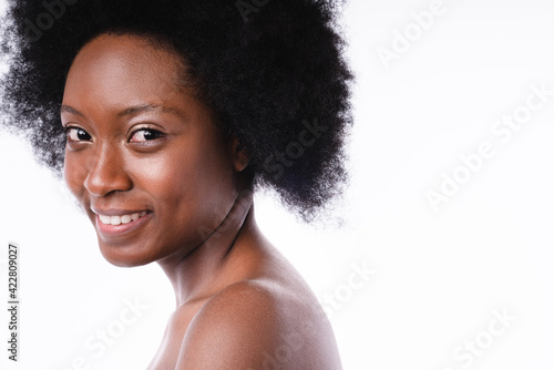 Side view portrait of a young african girl with clear skin isolated in white background