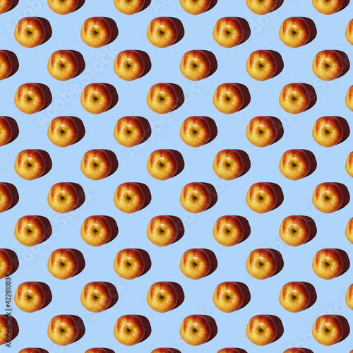 Fruit pattern from fresh red apples on a blue background. View Seamless apple pattern