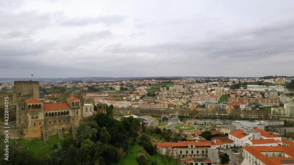 Aerial view overlooking the Leiria city, revealing castle, cloudy day, in Portugal - pan, drone shot Aerial view overlooking the Leiria city, revealing castle, cloudy day, in Portugal - pan, drone shot