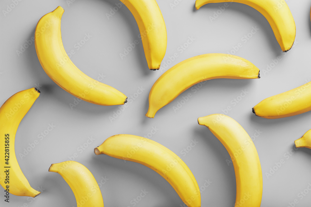 Bright pattern of yellow bananas on a gray background fashionable colors of 2021 Bright pattern of yellow bananas on a gray background fashionable colors of 2021