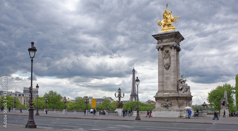  View of the Pont Alexandre lll. On the bridge are pedestrians and cars