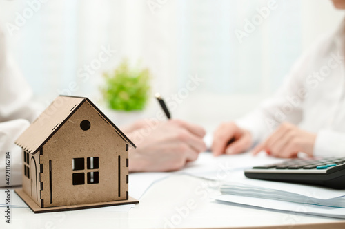 Real estate consultant and client sign the document. Mortgage or home purchase.