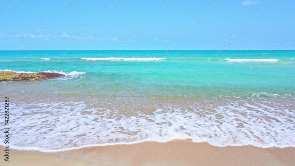 Vibrant color contrast of golden beach with turquoise water. Slow-motion Vibrant color contrast of golden beach with turquoise water. Slow-motion