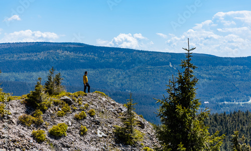 Fototapeta Naklejka Na Ścianę i Meble -  Man standing on the edge of cliff in Jizera mountains