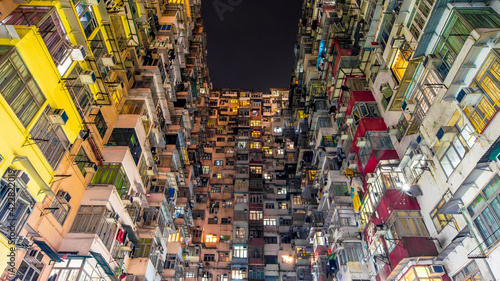 Photography Hong Kong business district and density residential at night with light trails on the street movement