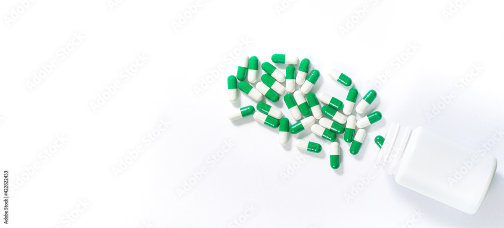 Assorted pharmaceutical medicine pills, tablets and capsules and bottle on white background. Top view. Flat lay. Copy space. Medicine concept. Heap of pills on white background