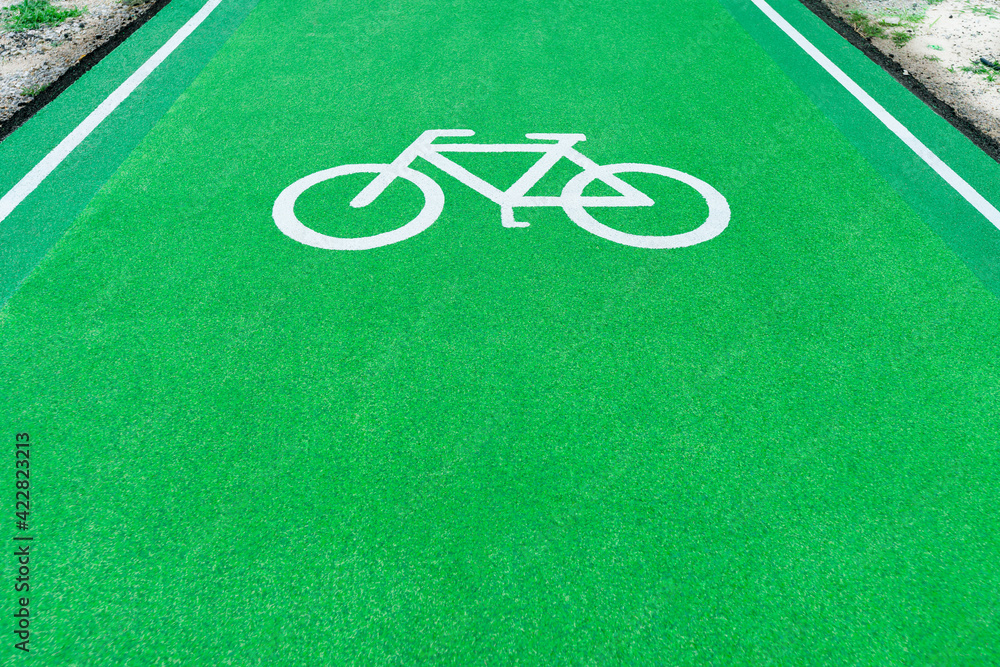 Obraz premium Symbol bicycle white in runway green. Path are for bicycle runway indicating a designated area for cycling.
