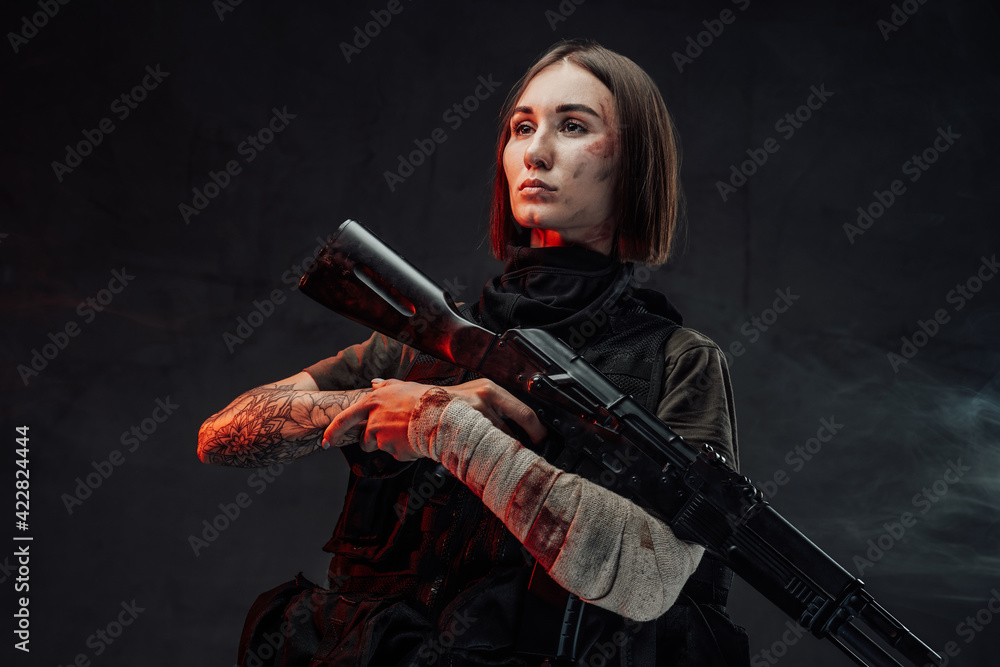 Beautiful military woman with bandaged hand and rifle Beautiful military woman with bandaged hand and rifle