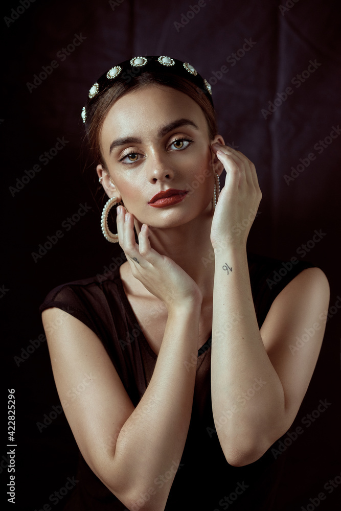Portrait of a young woman in a swimsuit, wearing a towel, hat, or headband on her head Portrait of a young woman in a swimsuit, wearing a towel, hat, or headband on her head